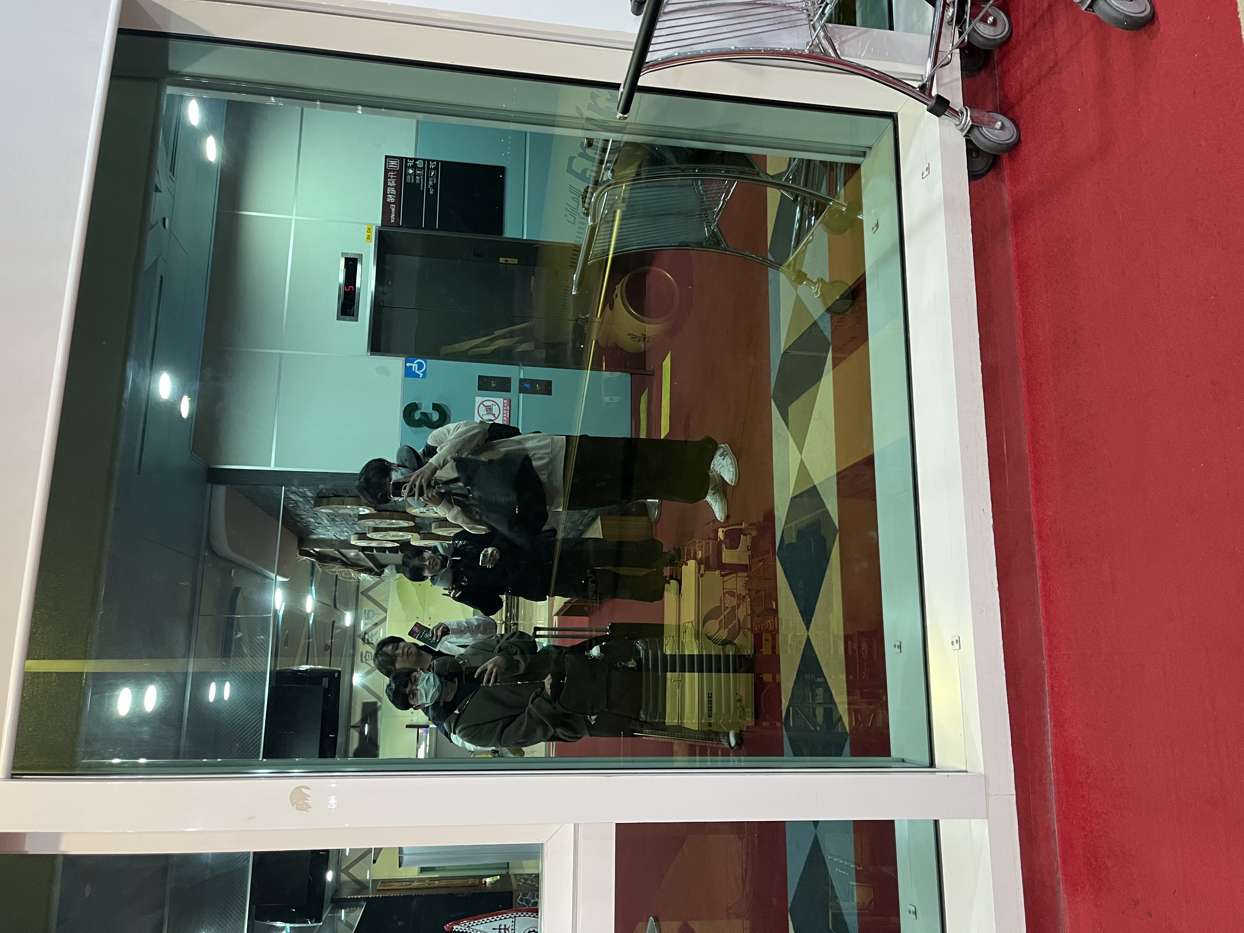 Group photo in the airport glass reflection